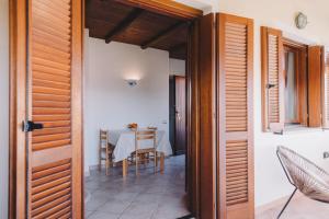 a dining room with a table and a table and chairs at Cactus Mare Apartment in Golfo Aranci