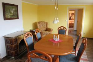 a dining room with a wooden table and chairs at Ferienhaus Frank in Letschow +8 photos