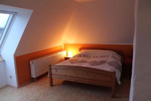 a bedroom with a bed with a signono home it at Ferienhaus Frank in Letschow