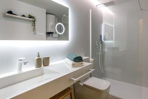 a white bathroom with a sink and a shower at La Capilla del Cabo Apt 3 in Cabo de Palos +15 photos