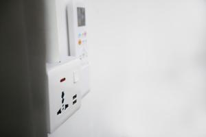 a white refrigerator with magnets on a wall at HangoutSpacez Queensbay at Bayan Lepas Penang in Bayan Lepas