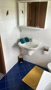 a bathroom with a sink and a mirror at Flussnest Fulda in Fulda +15 photos