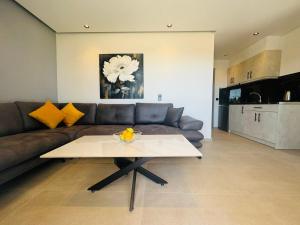 a living room with a couch and a coffee table at Joy Apartments in Limenaria