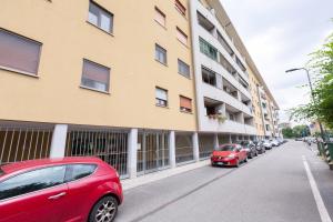 a row of cars parked next to a building at EasyTopStay - San Siro Large Flat in Milan