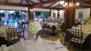 a room full of tables and chairs with white flowers at Hotel La Rotonda in Cepagatti