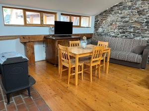 a living room with a wooden table and chairs at Travel Hostel in Český Krumlov
