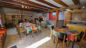 a kitchen with two tables and chairs in a room at Gites de france 6 personnes au teil in Albaret-le-Comtal