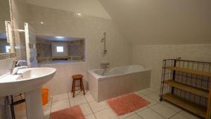 a bathroom with a sink and a bath tub at Gites de france 6 personnes au teil in Albaret-le-Comtal
