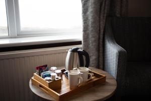 a tray with cups and a coffee maker on a table at Kinloch Hotel, Isle of Arran in Blackwaterfoot