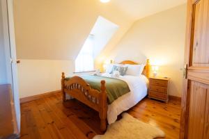 a bedroom with a large bed and a window at Dingle Town Cottage - Tigh Peig in Dingle