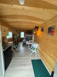 a room with a wooden wall with a table and chairs at Schäferkarrenpark Adler- und Wolfspark Kasselburg in Pelm