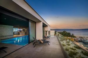 a balcony of a house with a swimming pool at Aminess Younique Narrivi Hotel in Crikvenica