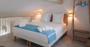 a bedroom with a bed with towels on it at VILLA SEPHORA CANNES in Cannes