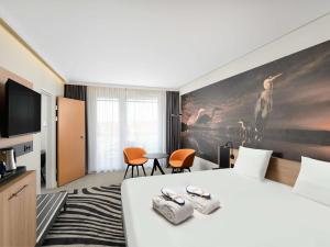 Postel nebo postele na pokoji v ubytování Novotel Szeged