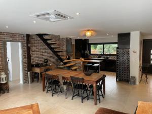 a kitchen and dining room with a wooden table and chairs at Petit paradis in Soustons