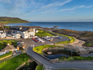 an aerial view of a parking lot next to the ocean at Kinloch Hotel, Isle of Arran in Blackwaterfoot