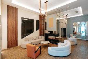 a living room with a couch and chairs and a chandelier at Empula Hotel & Residences in Trabzon