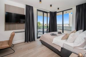 a bedroom with a large bed and a television at Villa Infinity Gem mit beheizbarem Pool in Medulin, Istrien in Medulin +52 photos
