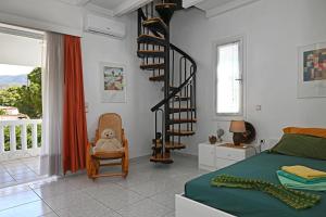 una camera da letto con un letto e una scala a chiocciola di Villa Supreme a Káto Alepokhórion Altre 84 foto