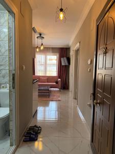 a hallway with a door and a living room at İlkay Apart in Kaleköy