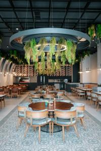 a dining room with tables and chairs in a restaurant at Empula Hotel & Residences in Trabzon