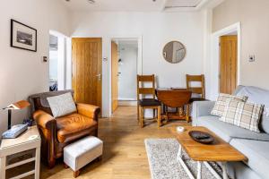 a living room with a couch and a table at Castell Bach in Llangollen