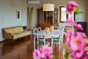 a living room with a table and chairs and a couch at Panoramic Loft in Chios