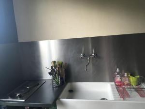 a kitchen with a sink and a counter top at Petite maison à la mer in Fort-Mahon-Plage +11 photos