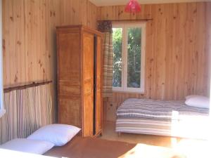 a bedroom with a bed and a dresser and a window at Petite maison à la mer in Fort-Mahon-Plage