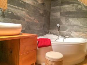 a bathroom with a sink and a tub and a toilet at Gîte du viala in Lanuéjols