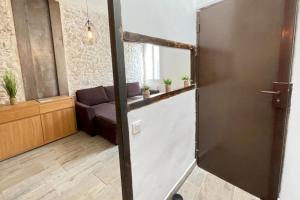 a living room with a couch and a door at Atelier des rêvesVieuxPortProche PlagesLaCiotat in La Ciotat
