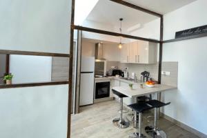 a kitchen with white appliances and a table with two stools at Atelier des rêvesVieuxPortProche PlagesLaCiotat in La Ciotat +21 photos