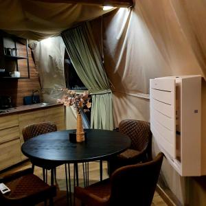 a small table in a room with a tent at Žvaigždžių slėnis - Kupolai in Sližiai
