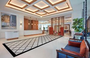 a lobby with couches and chairs and a ceiling at Doubletree By Hilton Bengaluru Whitefield in Bengaluru