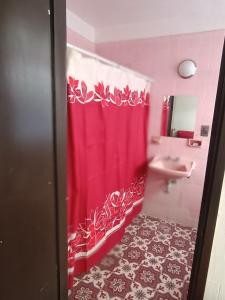 a bathroom with a red shower curtain and a sink at Hostal y hotel familiar china poblanan in Cuernavaca
