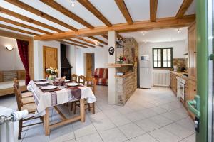 a kitchen and dining room with a table and chairs at Gite le mas 6 personnes in Allenc