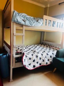 two bunk beds in a room with a bed at The urban nest in Kampala