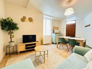 a living room with a couch and a table at Laon'Vert in Laon