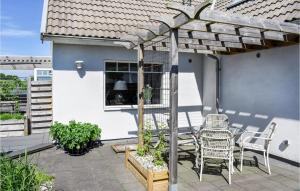 a patio with a table and chairs on a house at Three-Bedroom Holiday Home In Ystad in Ystad
