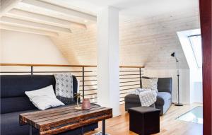a living room with a couch and a chair at Three-Bedroom Holiday Home In Ystad in Ystad