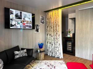 a living room with a couch and a tv on a wall at Luxury Camp at Union Lido in Cavallino-Treporti +133 photos