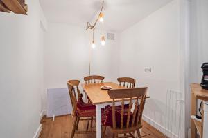 a dining room with a table and chairs at Pass the Keys Private Garden Apartment by Tulse Hill Station in London