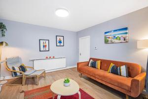a living room with a couch and a table at Pass the Keys Private Garden Apartment by Tulse Hill Station in London