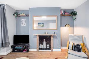 a living room with a mirror and a table at Pass the Keys Private Garden Apartment by Tulse Hill Station in London
