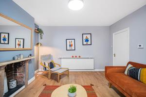 a living room with a couch and a fireplace at Pass the Keys Private Garden Apartment by Tulse Hill Station in London