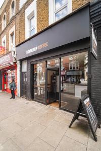 a store front with a sign in front of it at Pass the Keys Private Garden Apartment by Tulse Hill Station in London