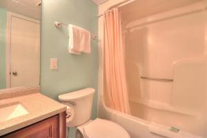 a bathroom with a toilet and a shower and a sink at 1114 Boundless Awe by Atlantic Towers in Carolina Beach