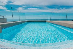a swimming pool on the roof of a building at Hotel Miramar in Lloret de Mar