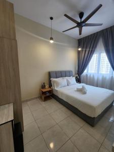 a bedroom with a bed and a ceiling fan at Youth City Nilai in Nilai