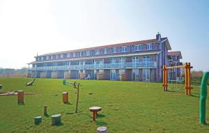 a large building with a playground in front of it at Apt 3 Hohen Wieschendorf in Hohen Wieschendorf